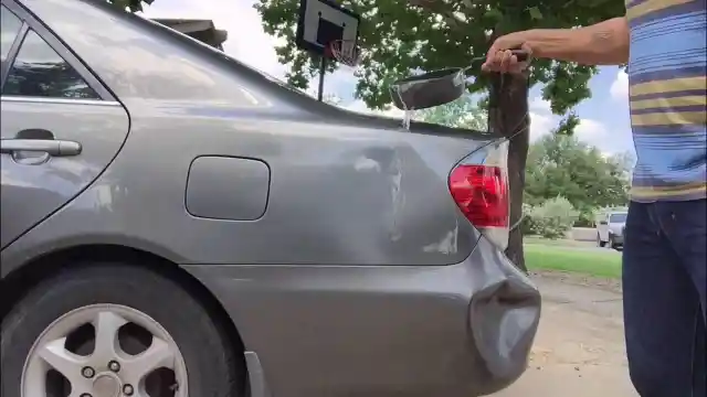 Repairing a Dent Using Hot Water and a Plunger
