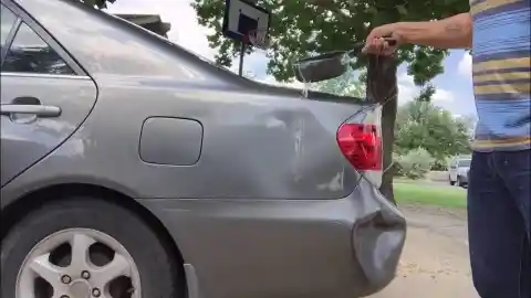 Repairing a Dent Using Hot Water and a Plunger