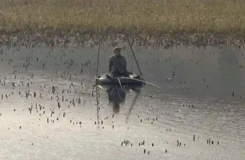 Fisherman Using Makeshift Tools And Equipment